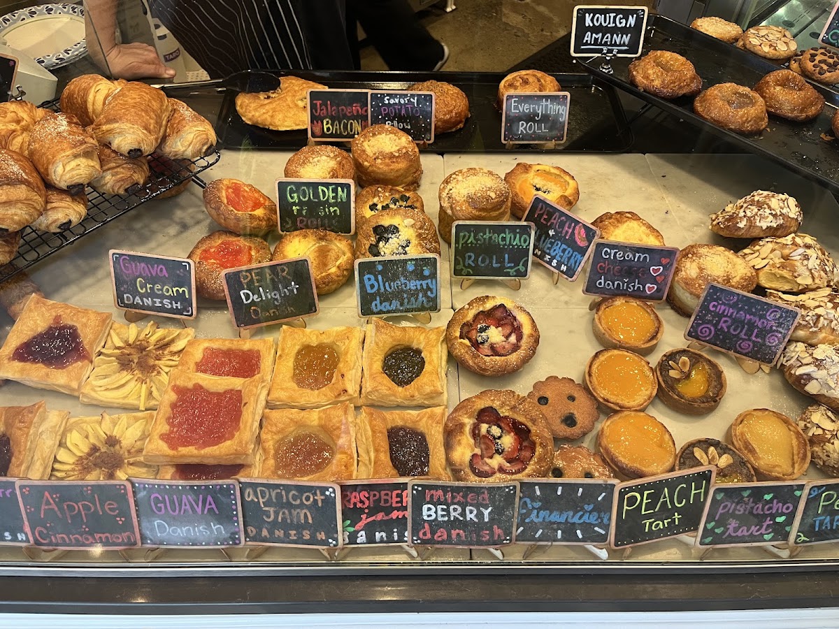 The Savour Bakery pastry case, filled with labelled danishes, rolls and tarts