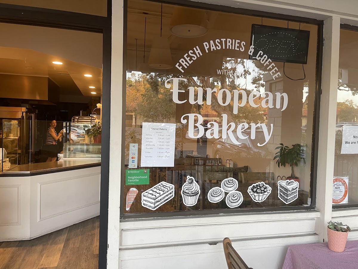 The Savour Bakery window, lettered European Bakery, with Nextdoor and Yelp badges
